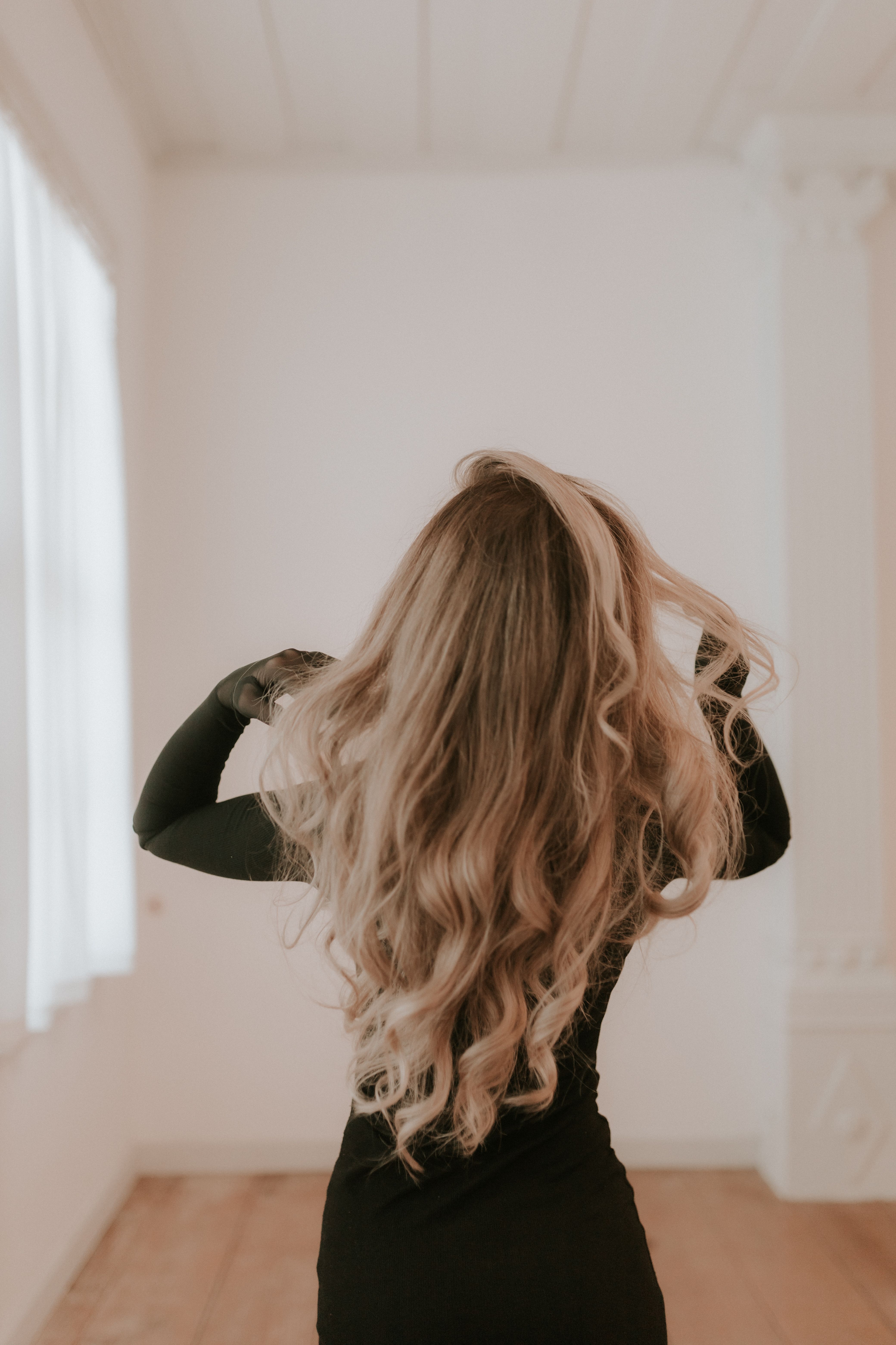 Long blonde hair styled in soft waves